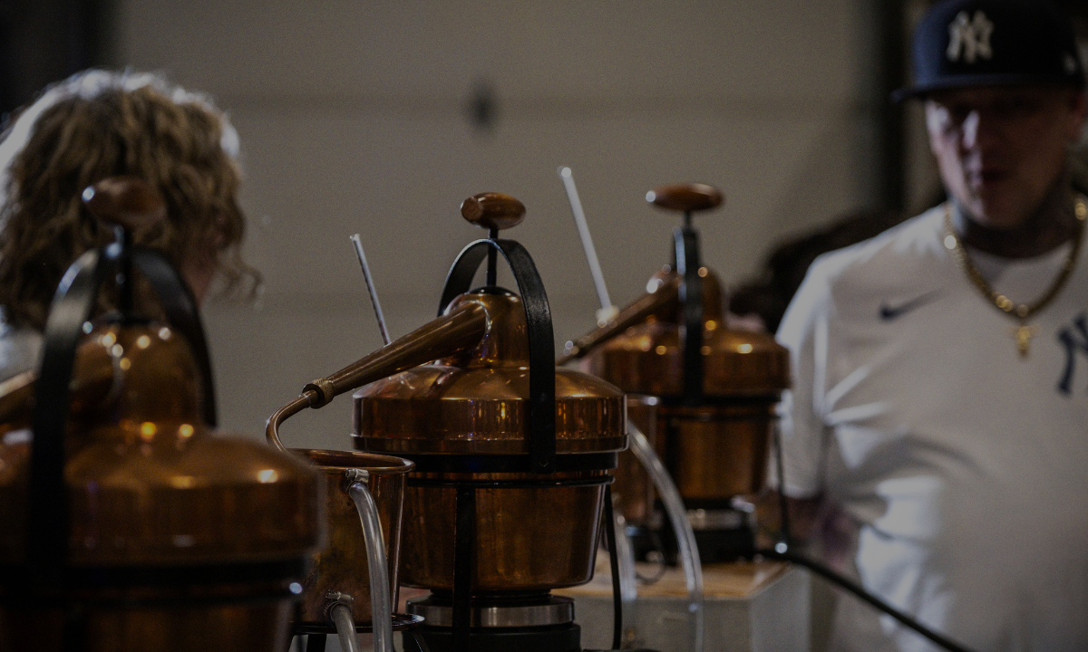 Gin still distilling custom gin blend while Master Distiller Kris looks on.
